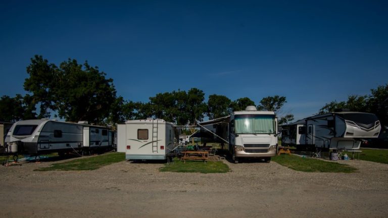 Four different RV motorhomes parked at campsite