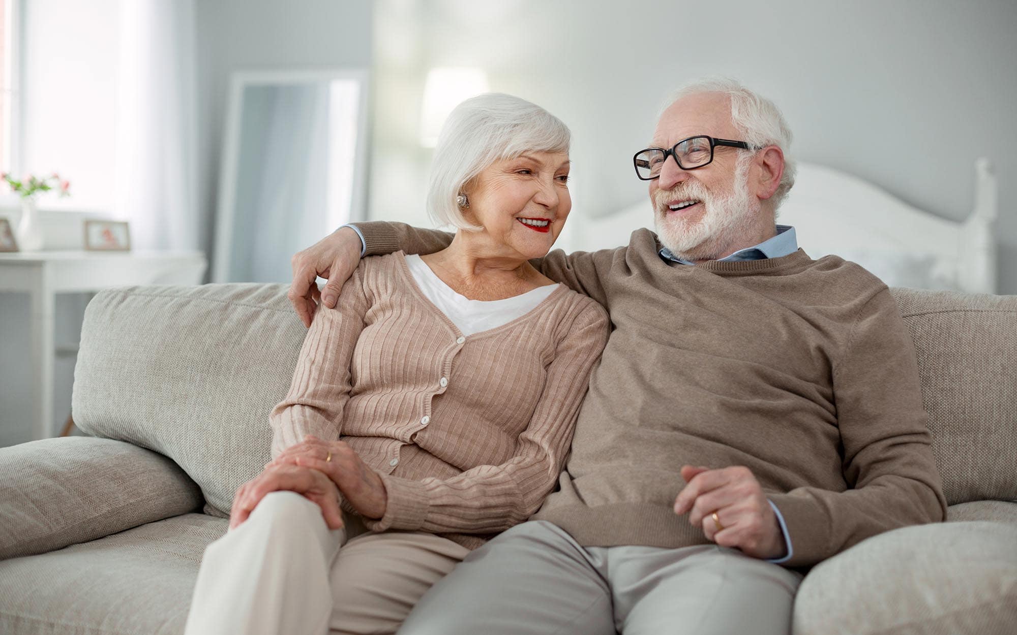 View of independent seniors sitting on couch View of independent seniors sitting on couch