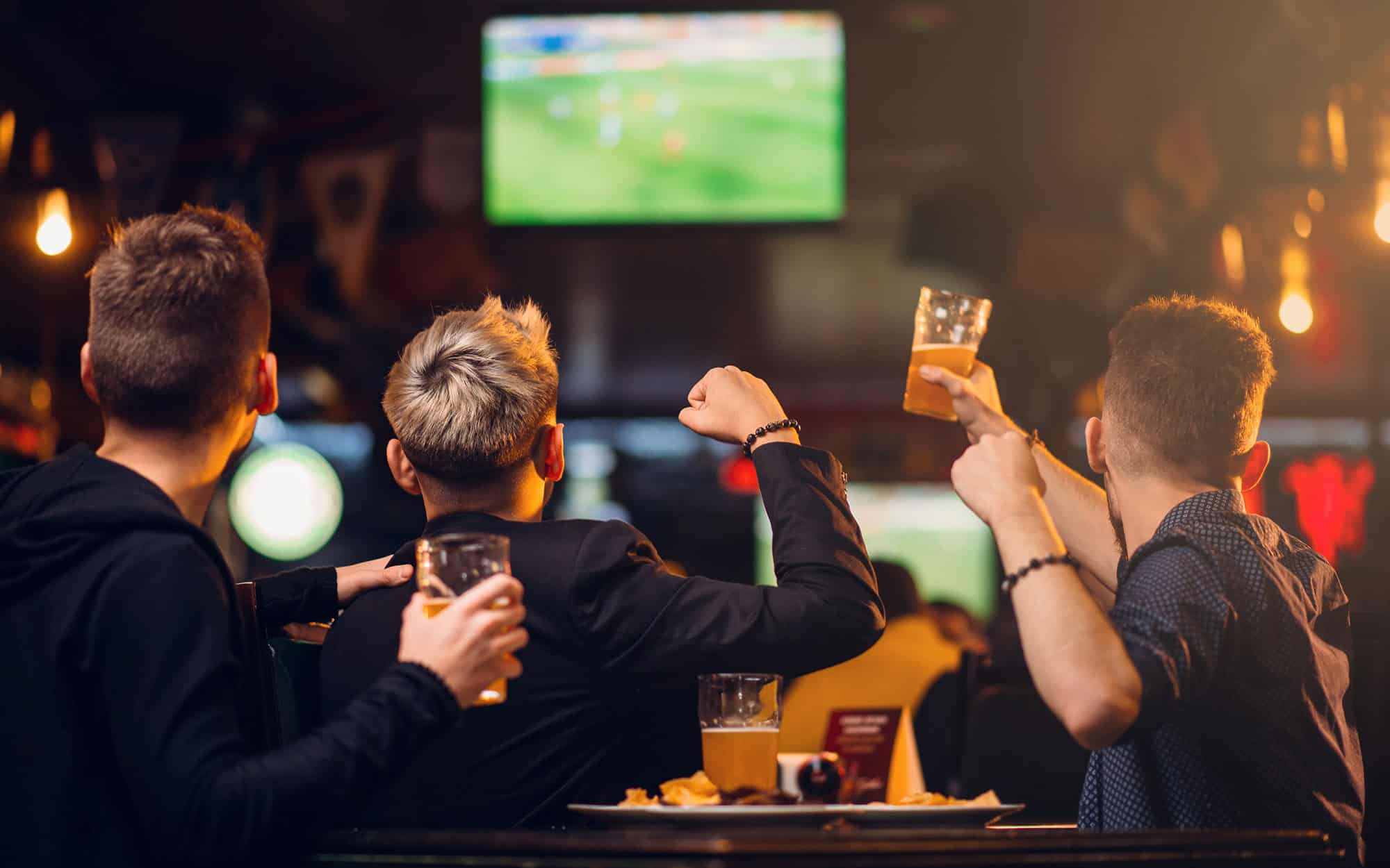 Back view of a group of men celebrating sports win