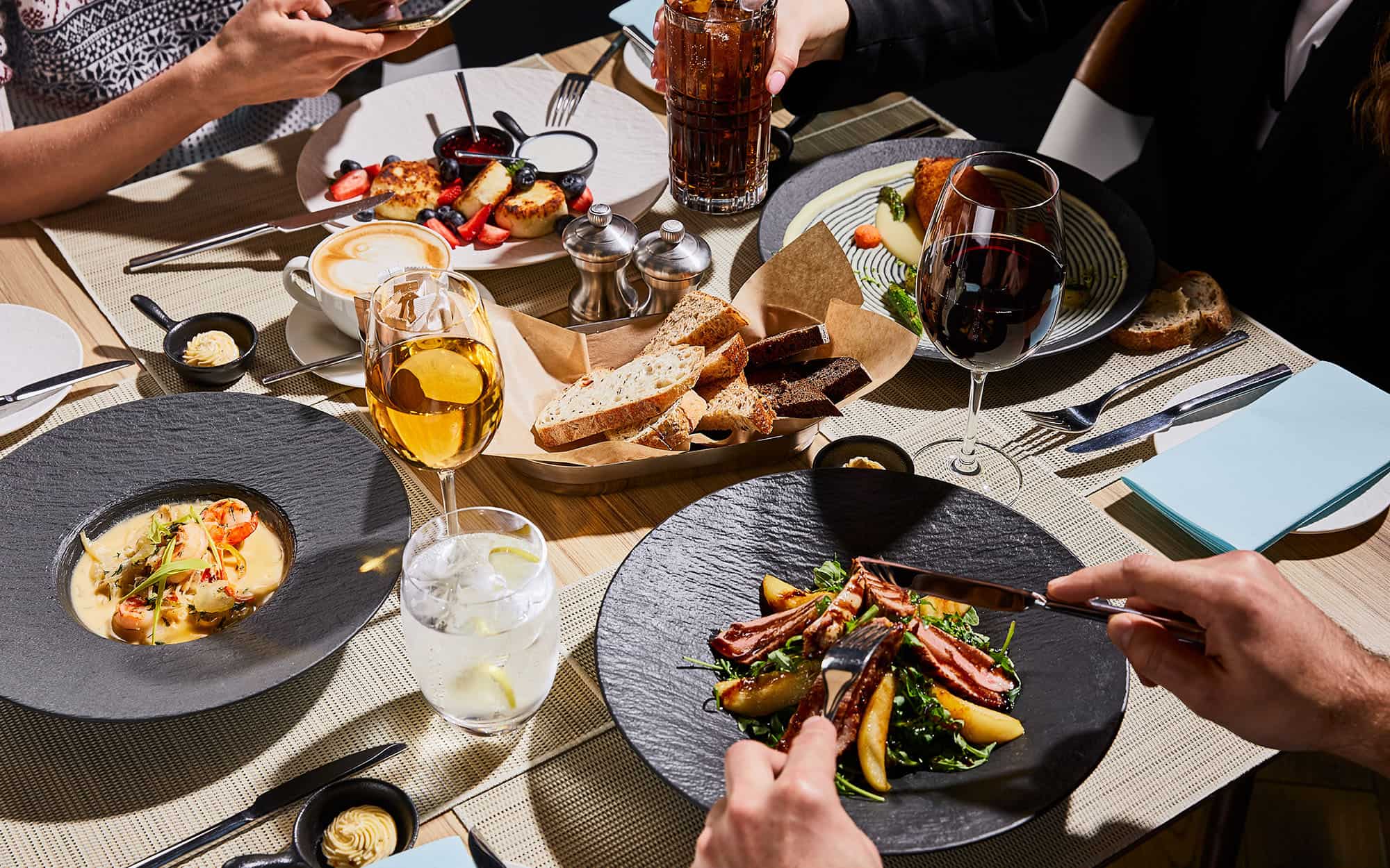Side view of people eating food at restaurant