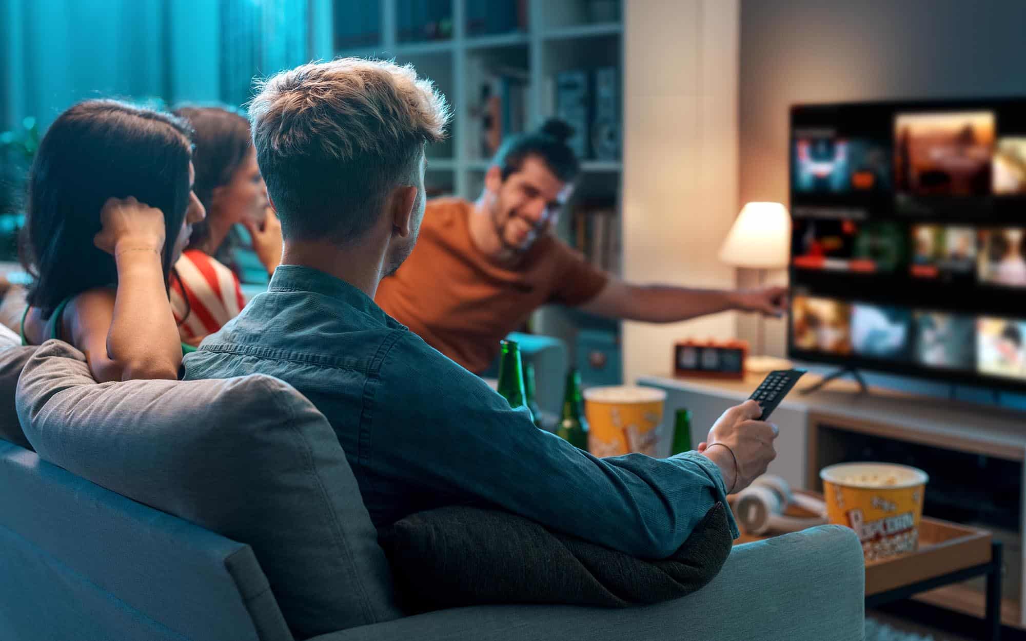 people sitting around tv in apartment living room